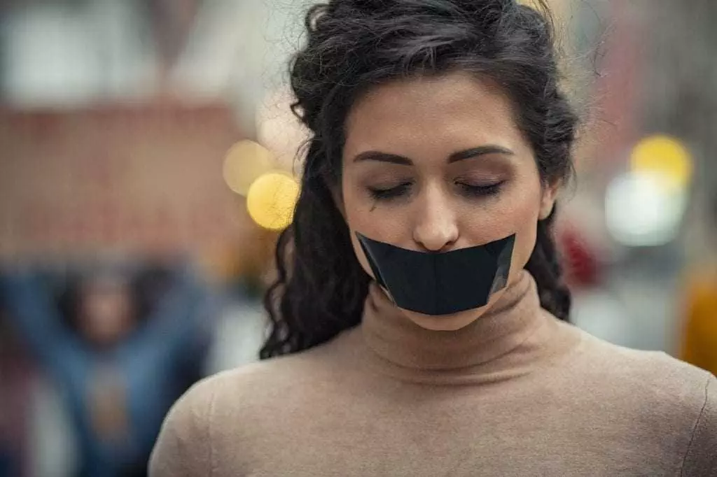 Woman fighting against harassment with closed eyes